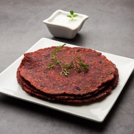 Indian food Beetroot paratha served with Curd, selective focus